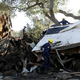 Search and rescue personnel scan a home in the aftermath of a mudslide Saturday, Jan. 13, 2018, in Montecito.